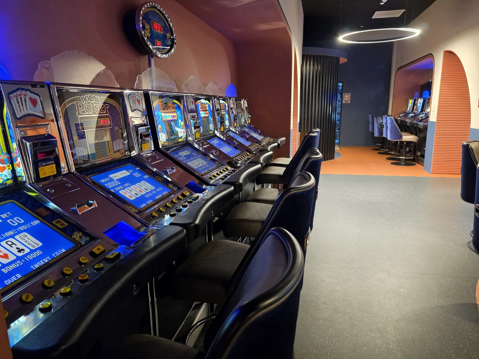 Classic gaming machines along orange-toned walls
